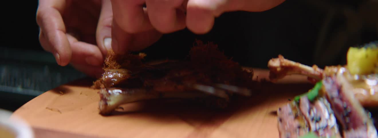 A person works on a food dish