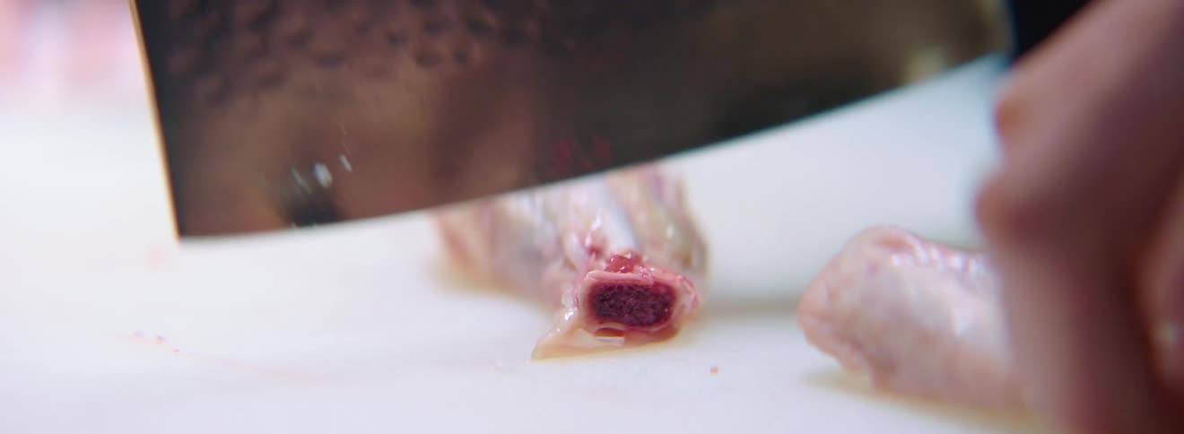 A person cuts meat