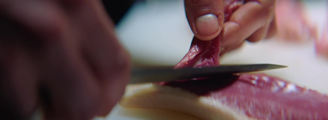 A man slices raw meat