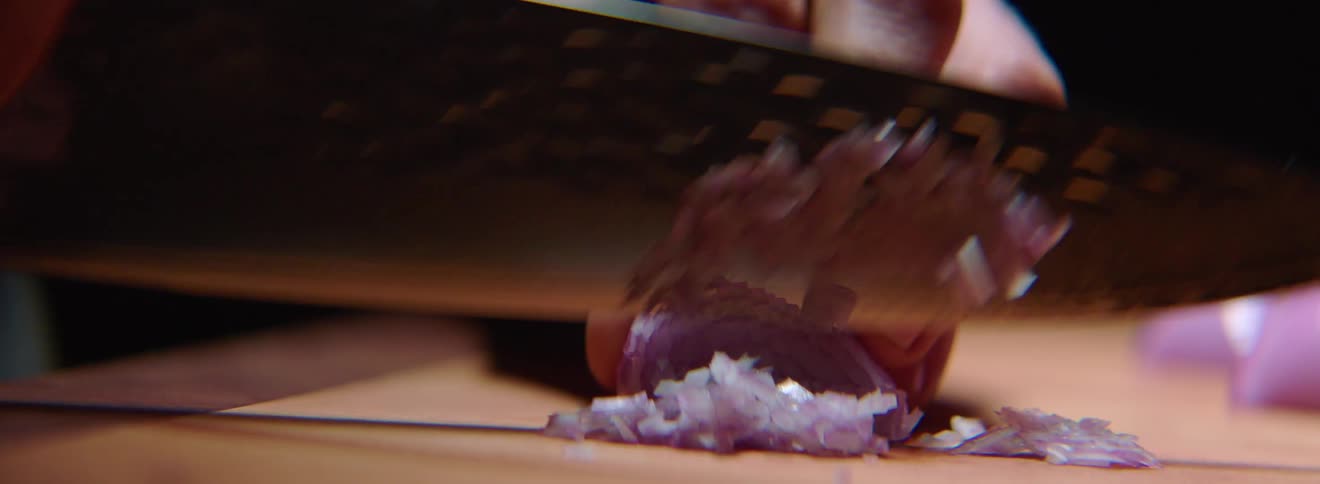 A person slicing onions with a knife