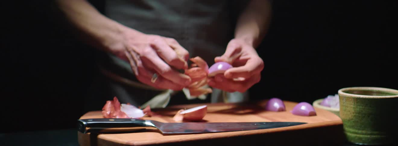 A man is preparing a meal on the cutting board