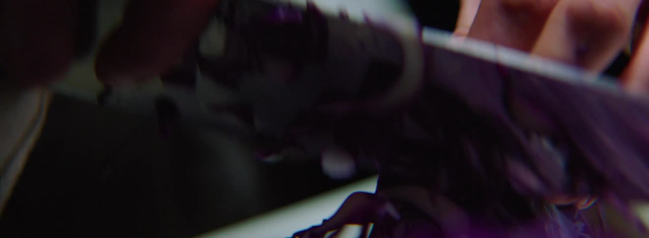 A male chef is chopping red cabbage with a sharp knife in his right hand