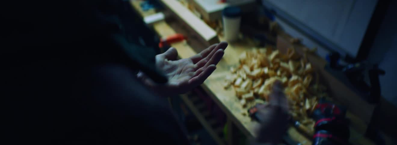 A white man wipes his hands clean with a red rag