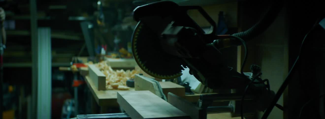 Flashing strobe lights in a workshop filled with wood and saws