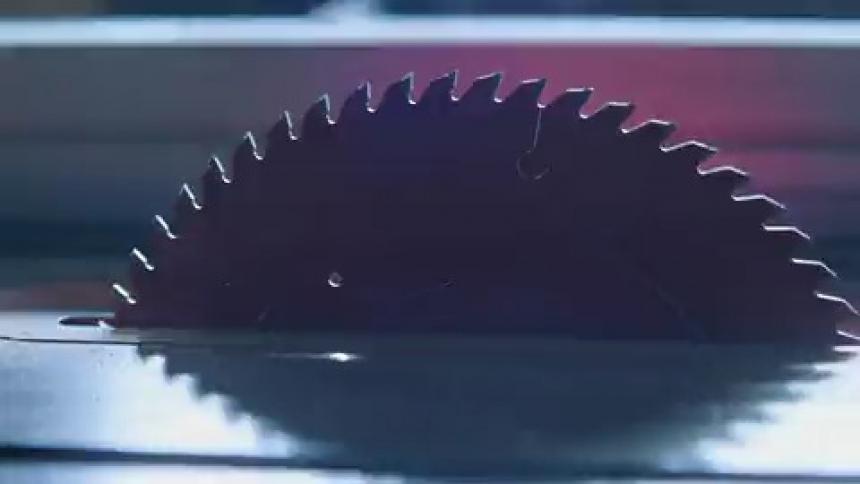 A strobe light illuminates a saw blade
