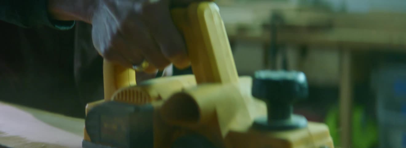 Person sanding a piece of wood
