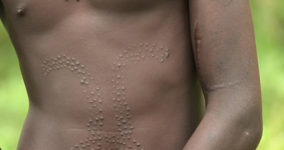 An african tribesman with patterned scarring on his body