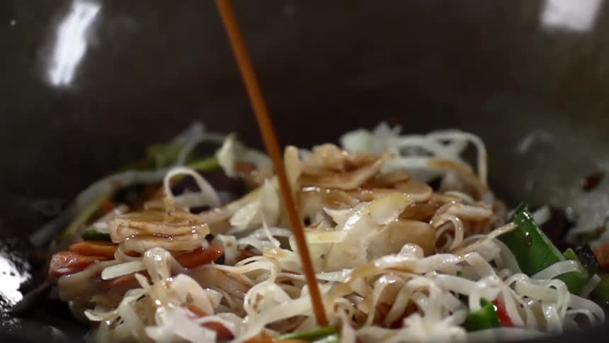 Vegetables in a pot with sauce being poured on it