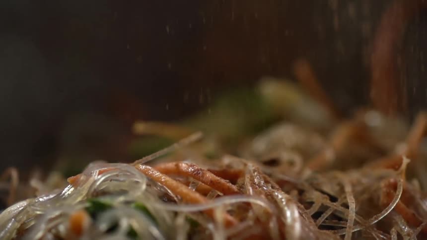 Seasoning falls onto a plate of food