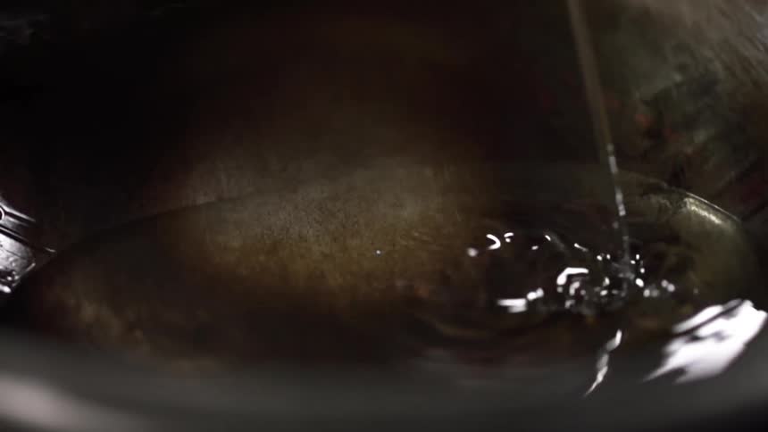 Oil being poured into a wok