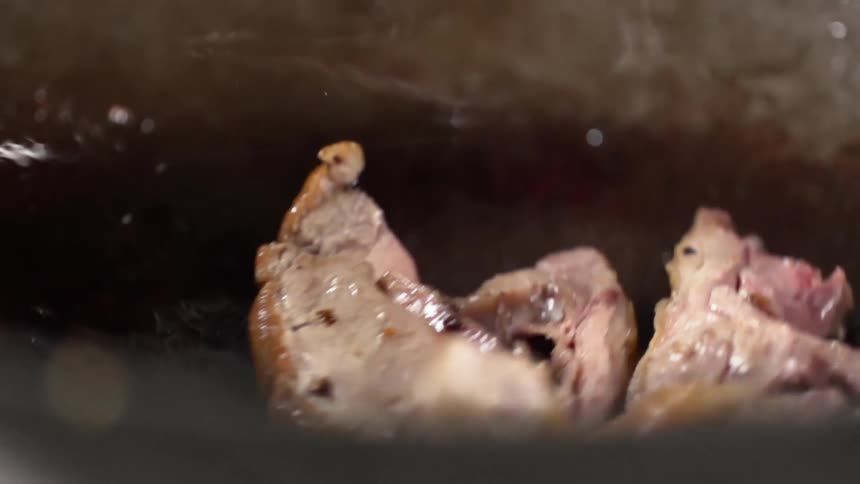 Meat is dropped into the oiled wok