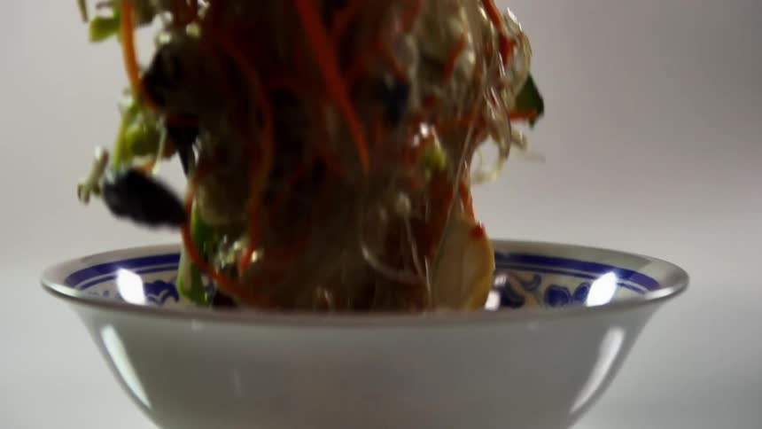 Glass noodles with vegetables served on a ceramic bowl