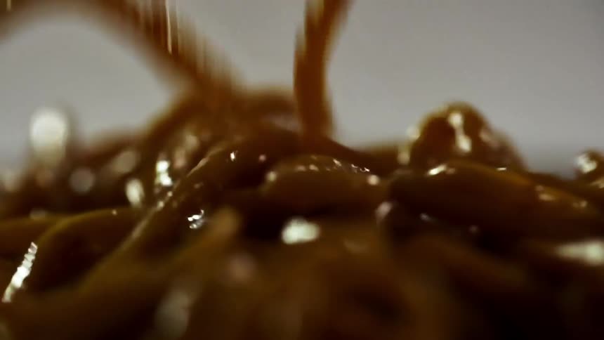 Udon noodles cooked in soy sauce is dropped in a pile