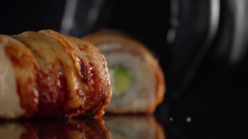 A person moves sushi on a table