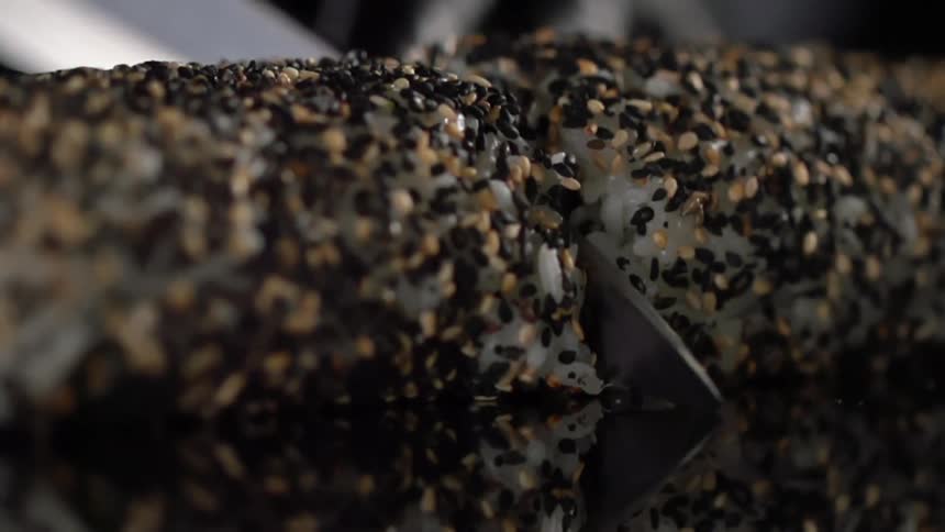 A sushi roll being cut
