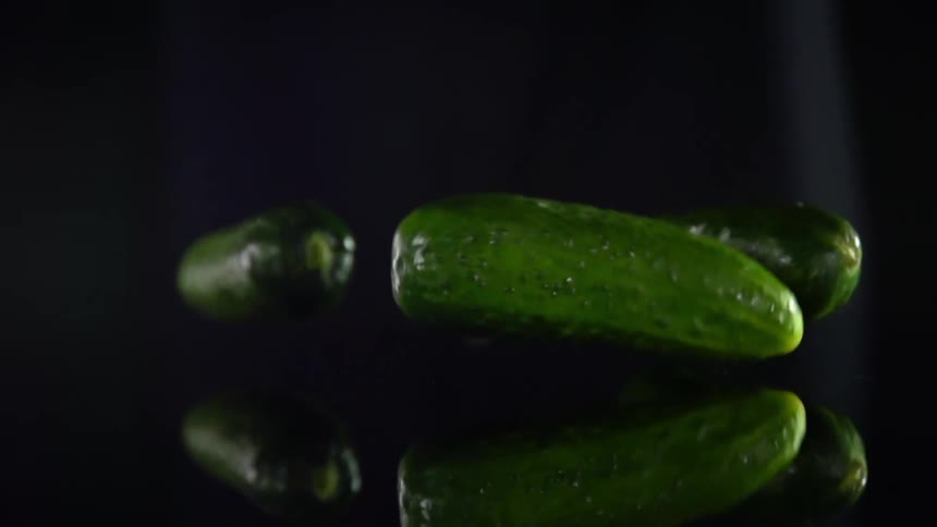Cucumbers falling on to a counter