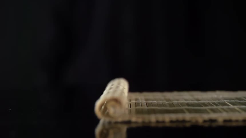 Bamboo mat is being unrolled in studio