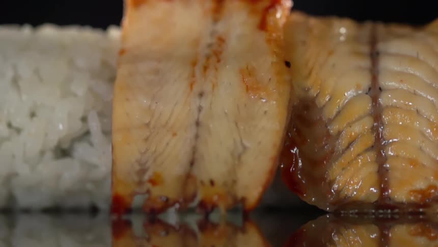 Seafood is placed on the rolled rice