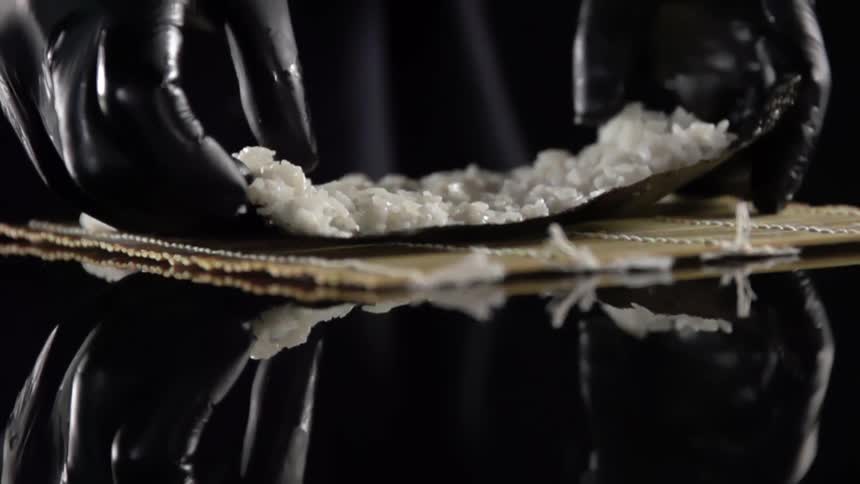 A person cooking sushi
