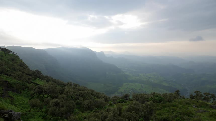 Time lapse of a mountain rage with heavy clouds moving above