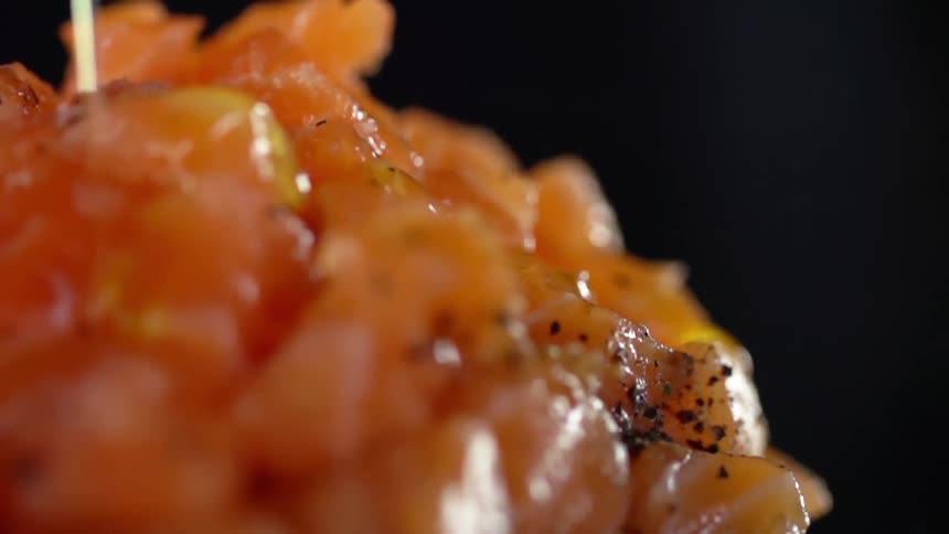 Sauce is being poured on the sushi