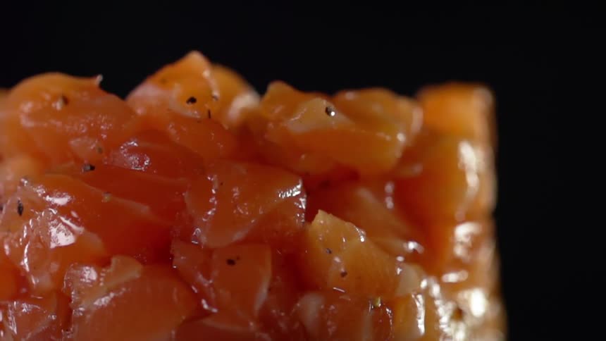 Pieces of raw tuna are molded into a stack seasoned with black pepper