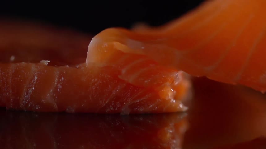 A piece of salmon being unfolded on a counter