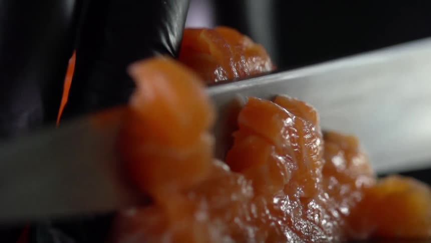 A person cutting fish