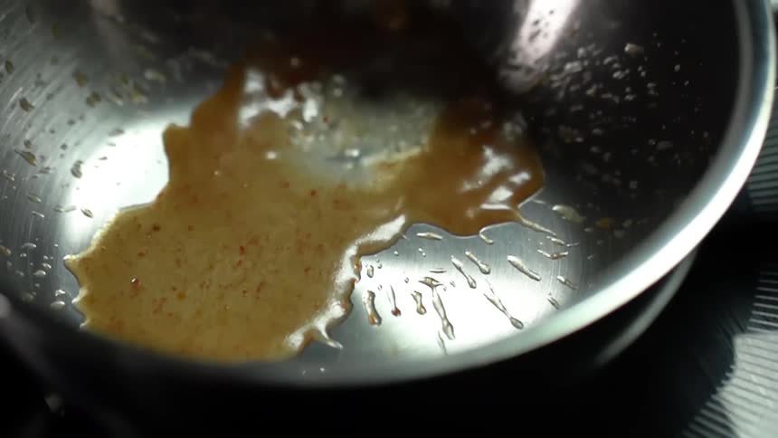 Broth is being poured into a saucepan
