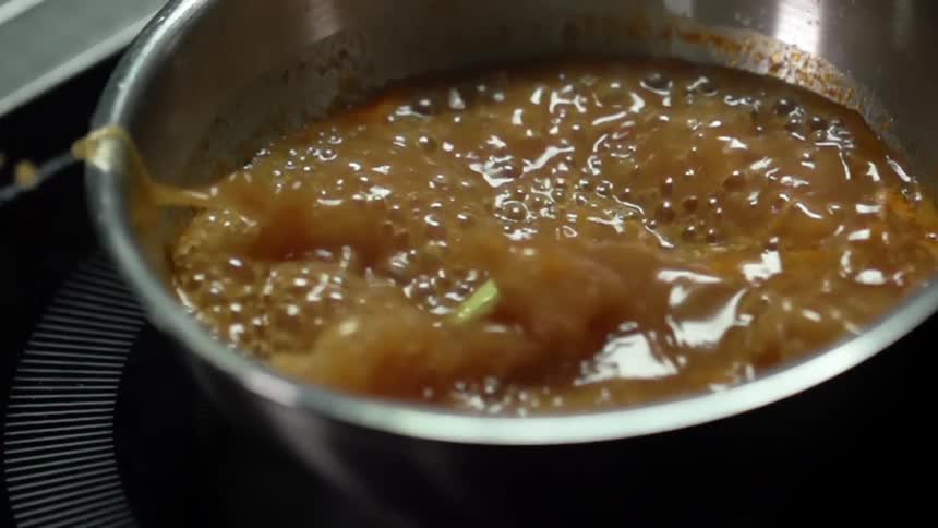 Celery is added to a pot of boiling soup