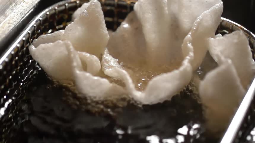 Shrimp chips are fried in a deep fryer