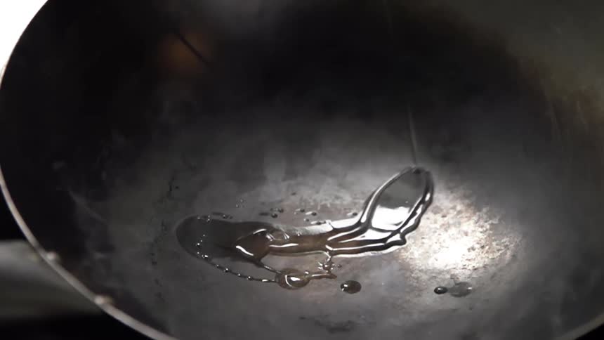 Oil is poured on the wok