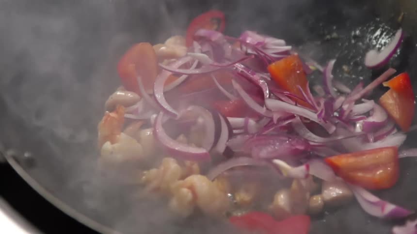 Meat and vegetables frying in a wok
