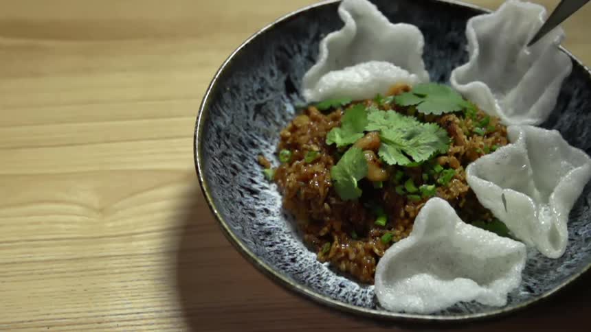 Some rice chips are placed on a plate with a meal