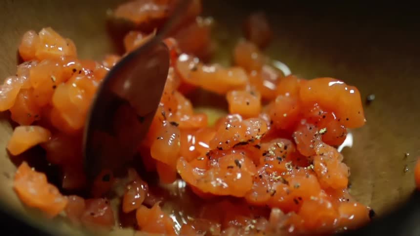 Seafood being stirred with seasonings