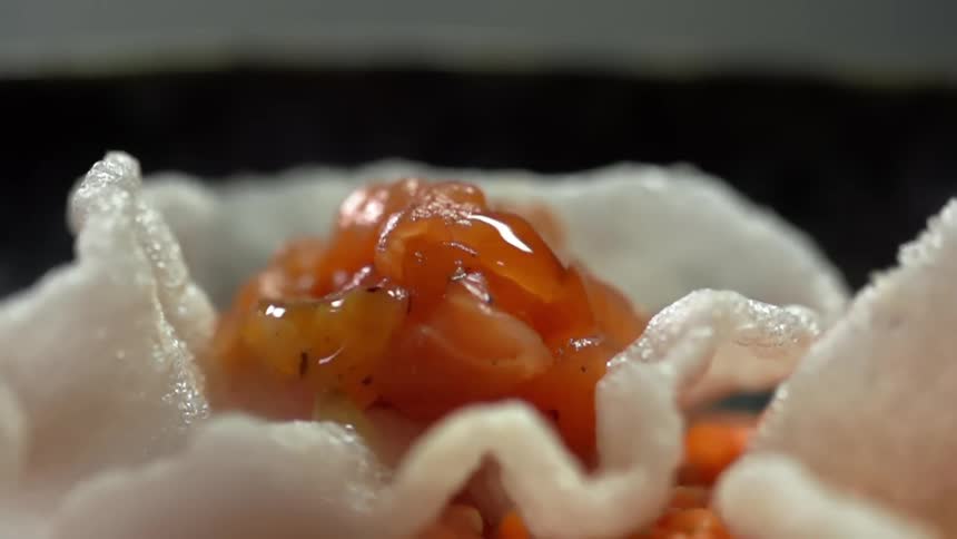 Oil dripping on to salmon in a rice chip