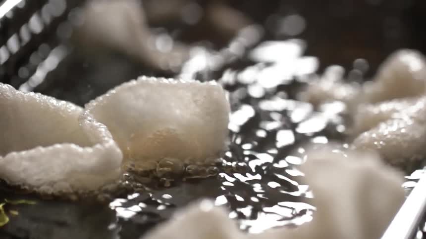 Shrimp chips are fried in a deep fryer