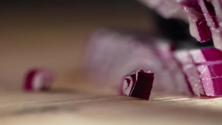 A red onion is sliced and diced into small pieces