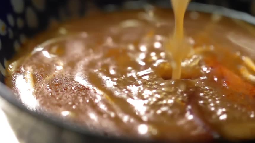 Broth is added to a bowl of noodle soup