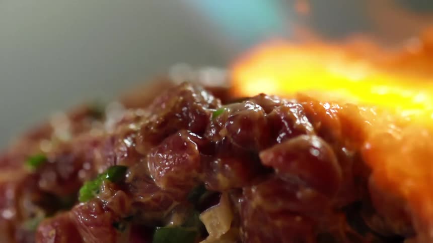 Fire and flames burning over tuna and vegetables