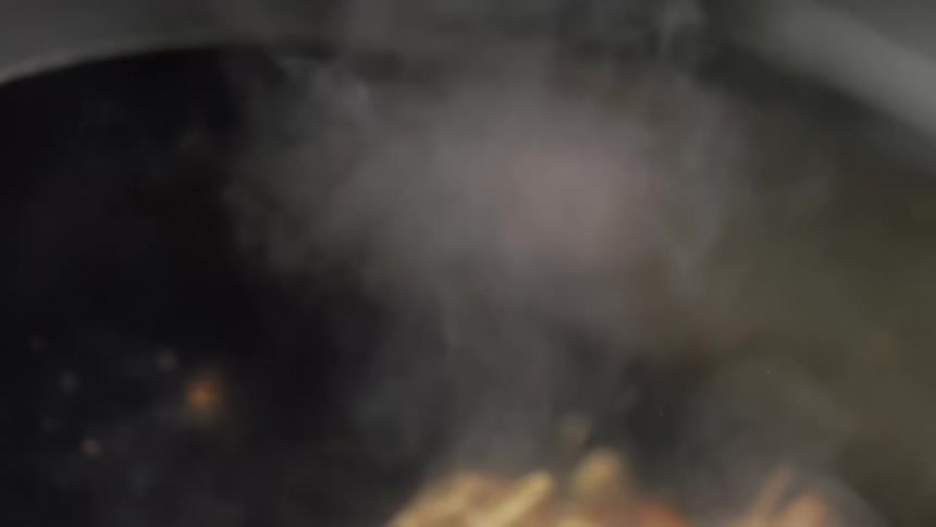 Stir fry food bounces around while cooking in a wok