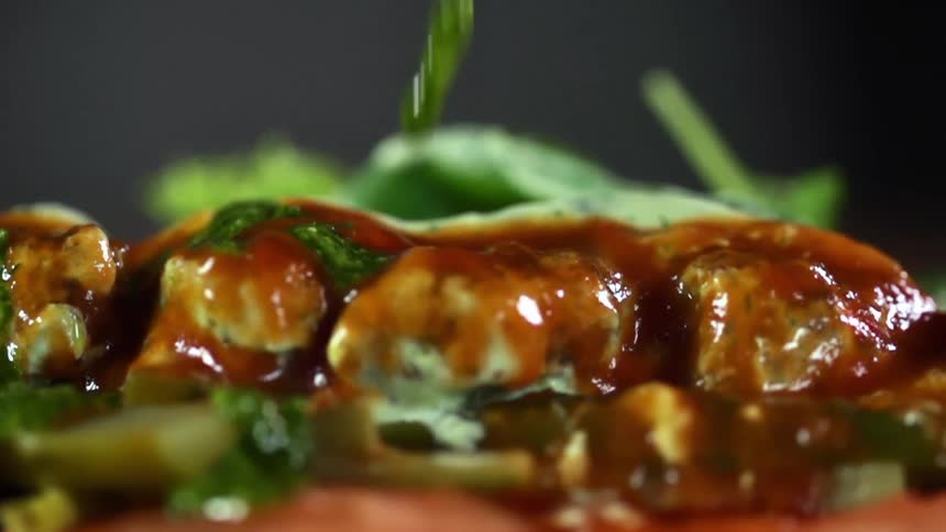 Green sauce drips on a meal