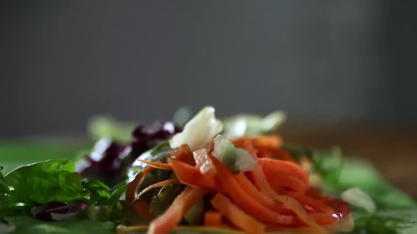 Lettuce falling on to a plate of vegetables