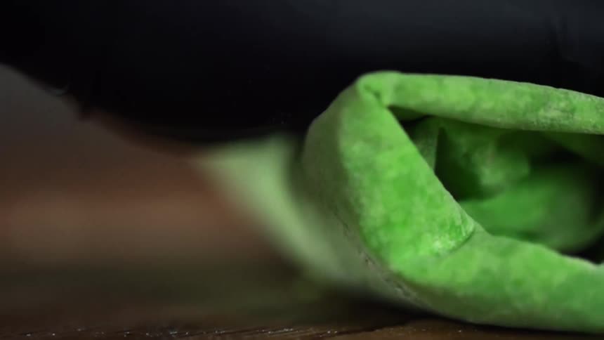 A person is rolling food on the table
