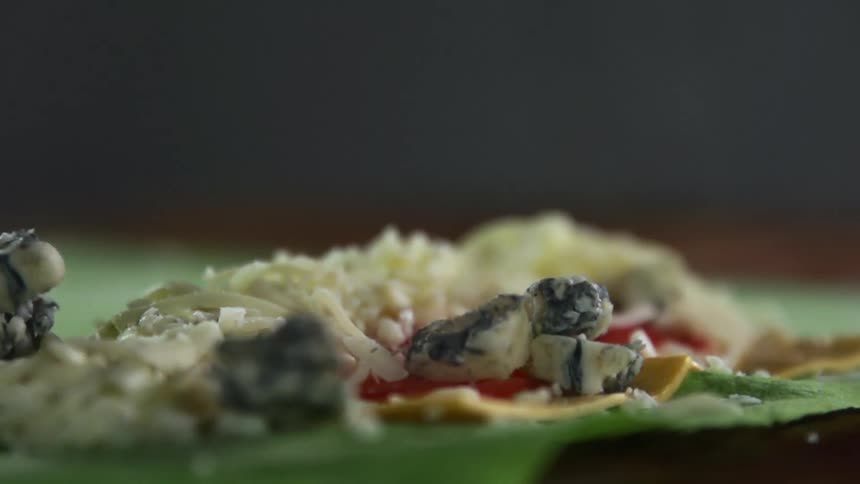 Several chunks of food drop onto a meal