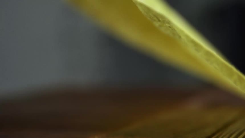 Unrolling a long tortilla flour over a wooden table