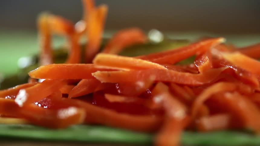 Carrot slices are dropped on the tortilla
