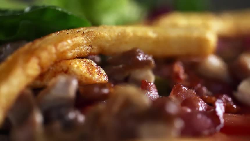 French fries are dropped on the meat dish