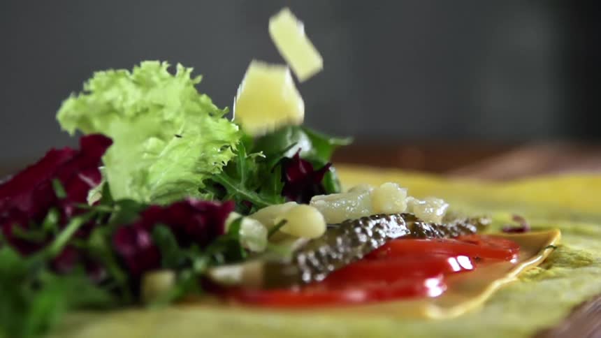 Fruit chunks drop on a leafy salad