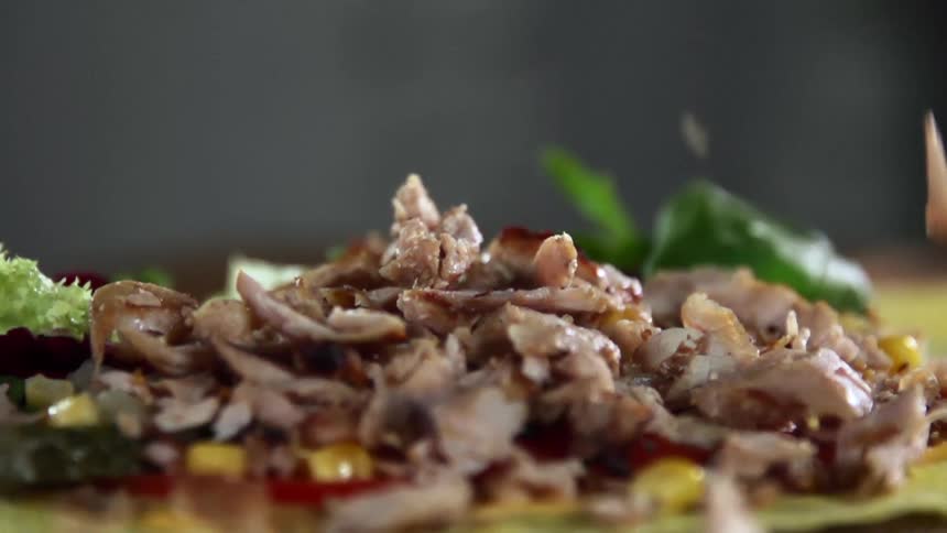 Meat falling on to a tortilla